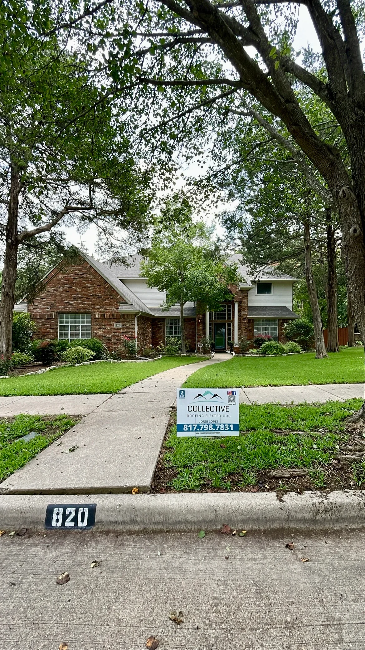 Two-story brick home with new roof installation, pitched design, brick and siding exterior