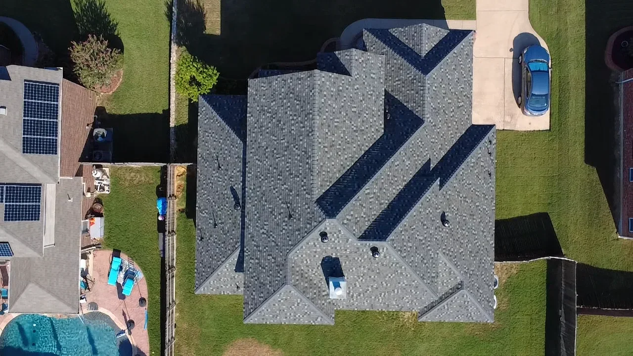 Aerial view of new gray and navy architectural shingle roof with chevron pattern design