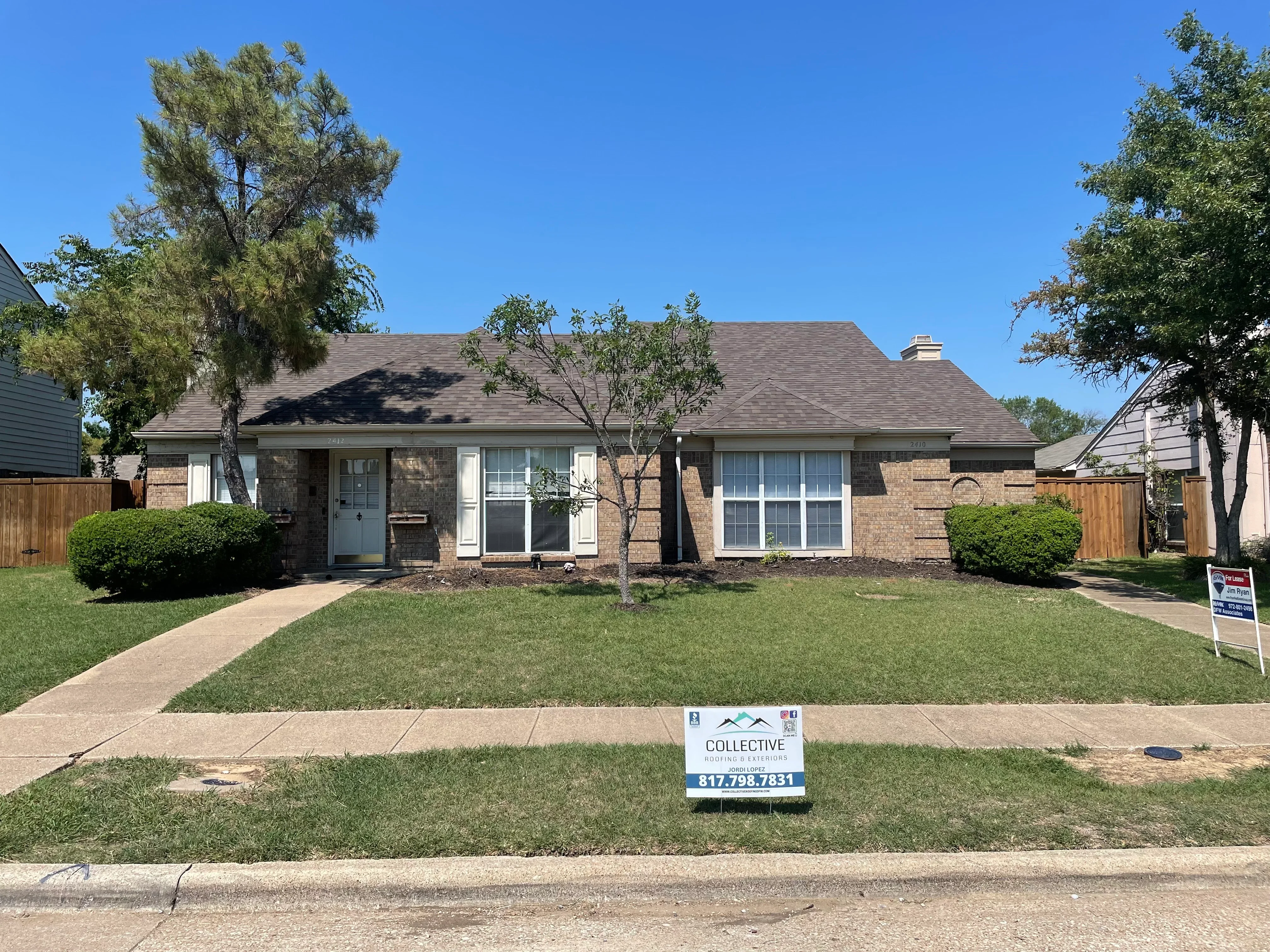 New dimensional asphalt shingle roof on brick single-story home with gray color and proper flashing