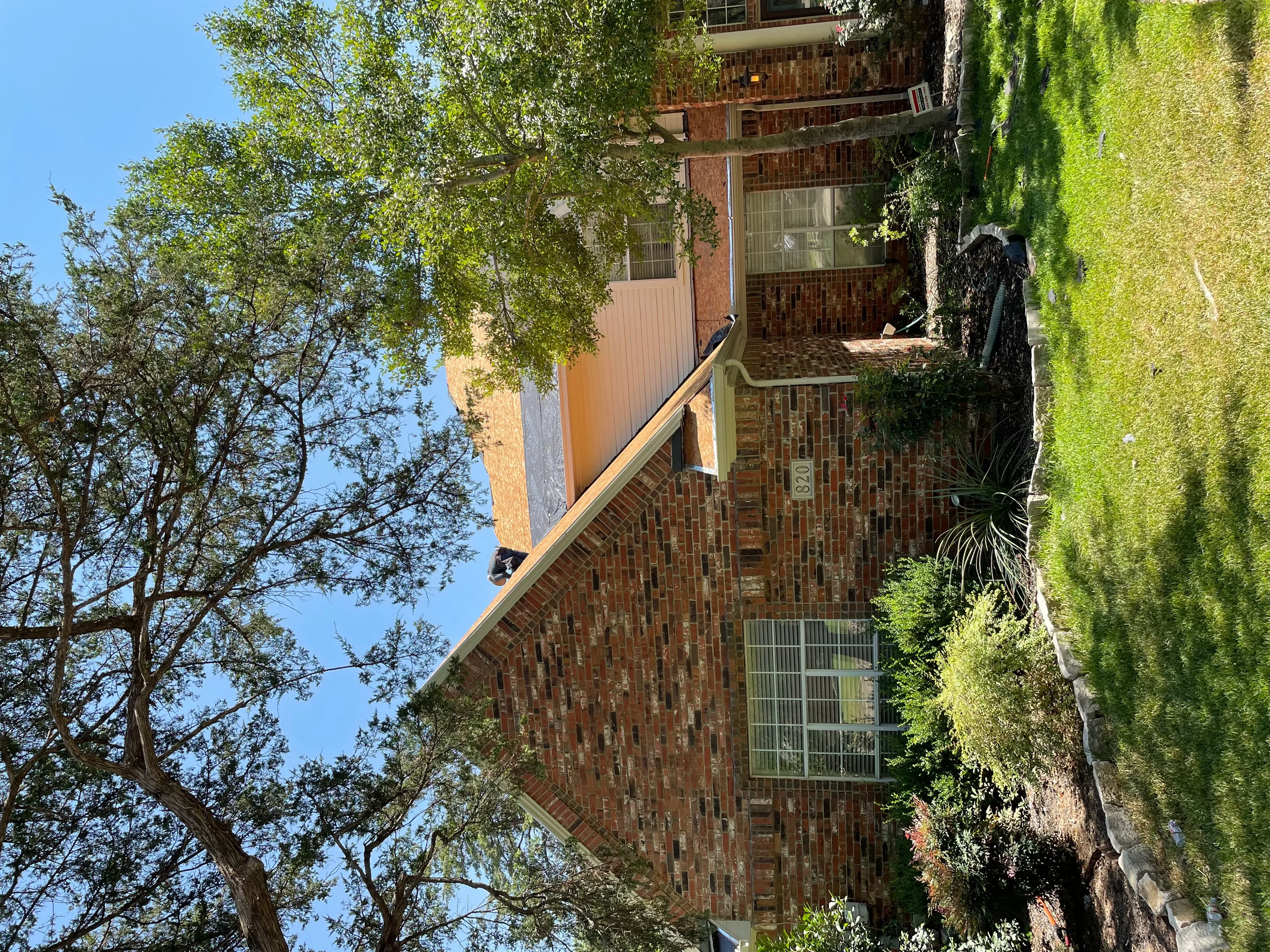 Brick residential home with newly installed dimensional asphalt shingle roof