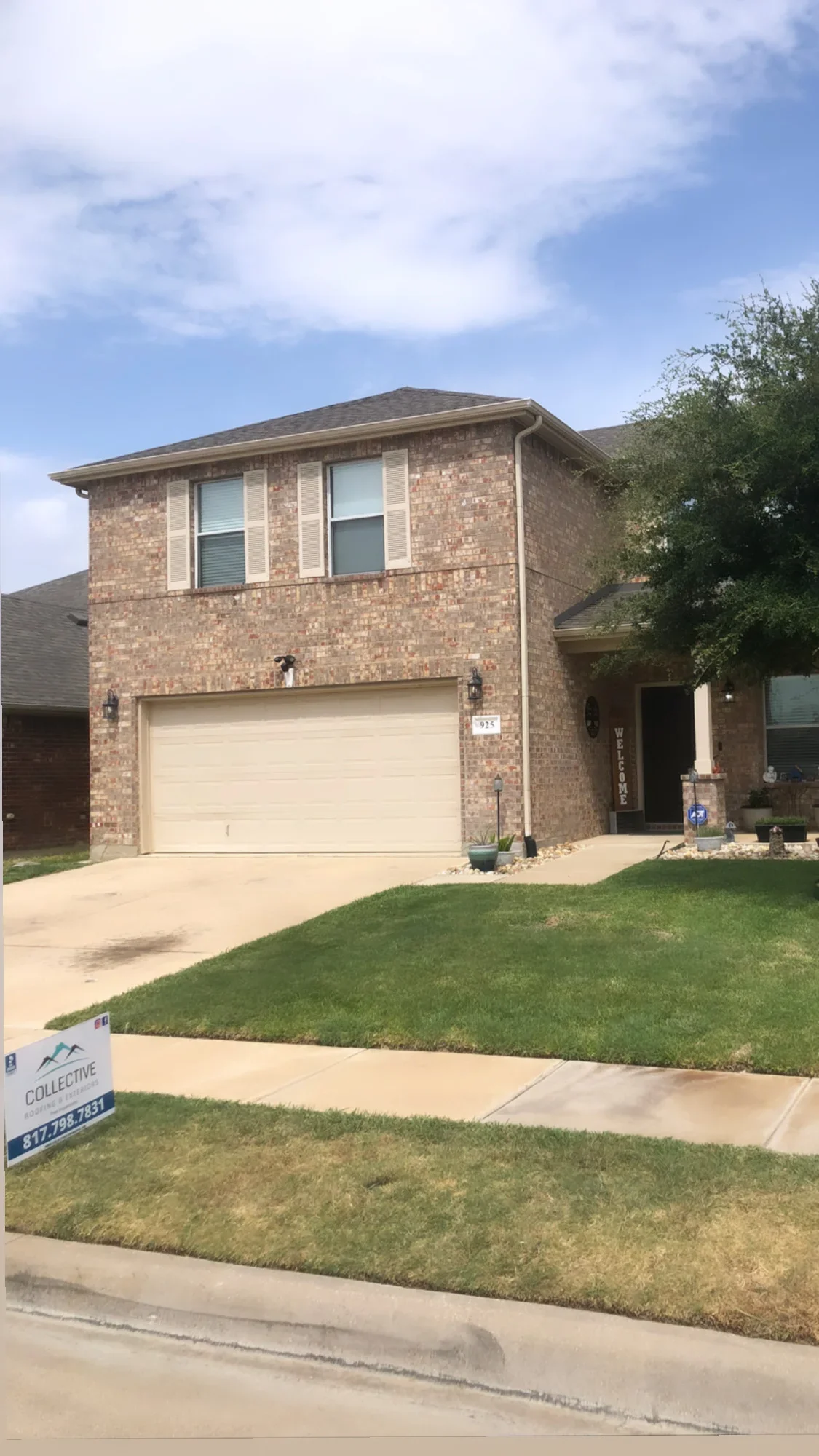 Two-story brick home with new dimensional asphalt shingle roof and gutters installed