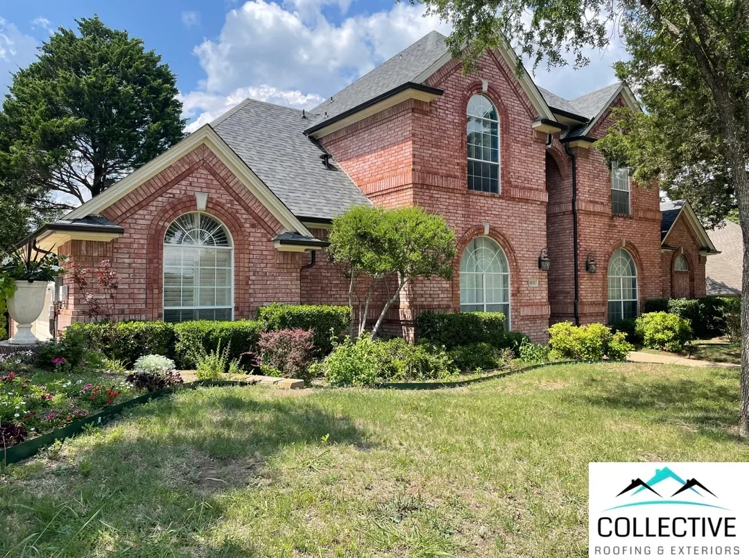 Two-story brick home with new gray architectural shingle roof installation