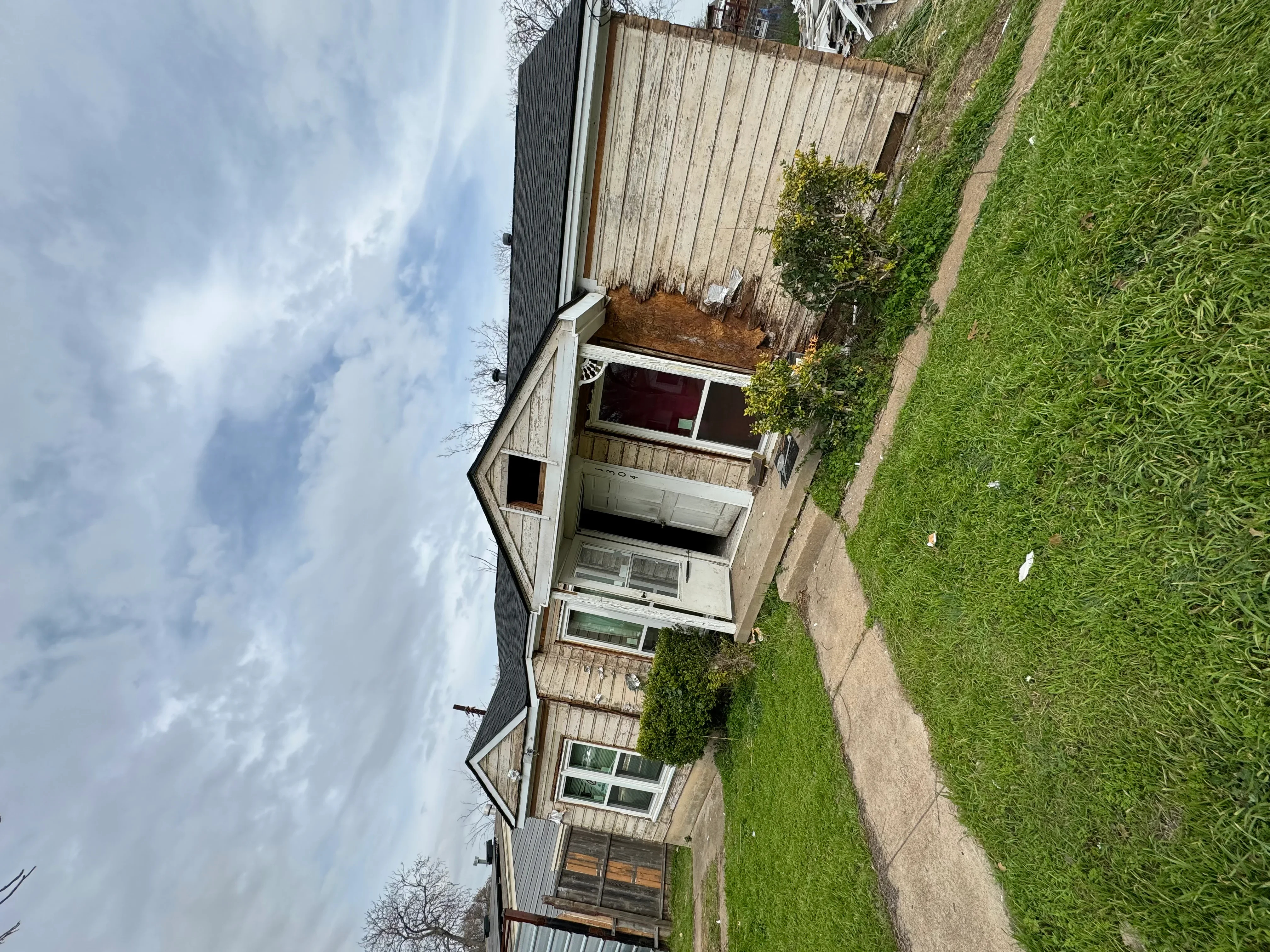 Dark gray standing seam metal roof installed on residential home with proper flashing and gutters
