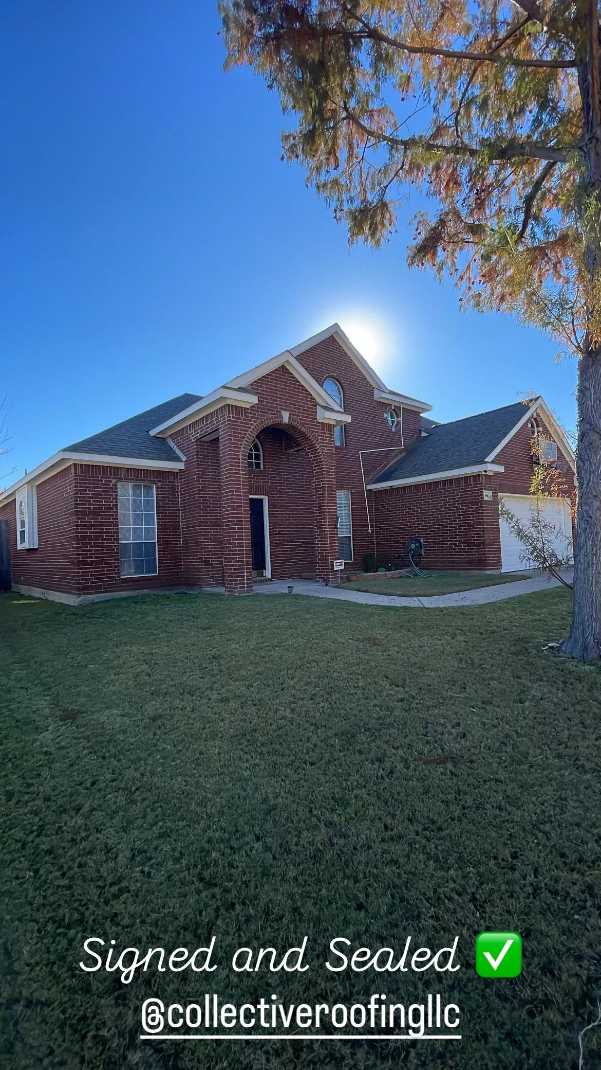 Two-story brick home with newly installed dark architectural shingles and sealed roofing system