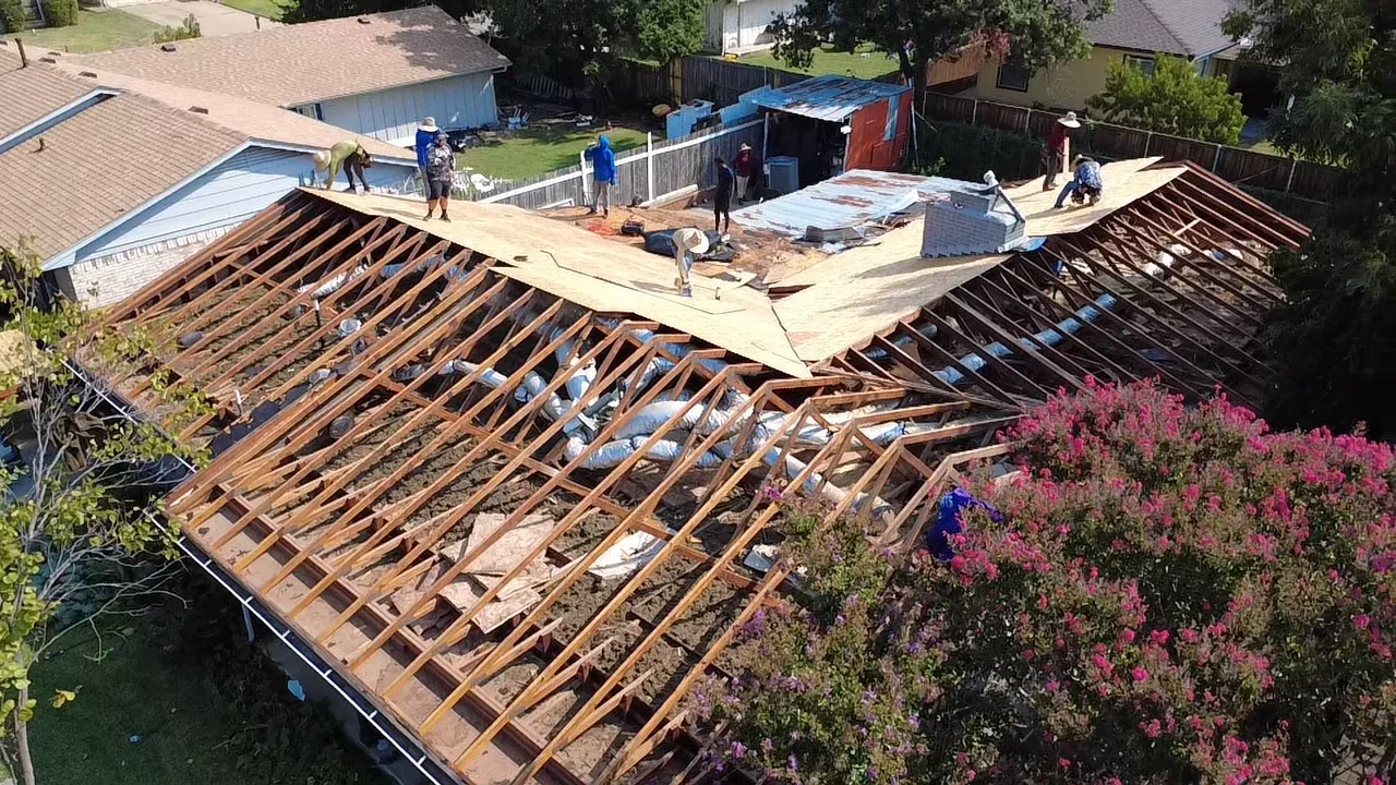 Wooden roof trusses and plywood decking during residential roof framing installation