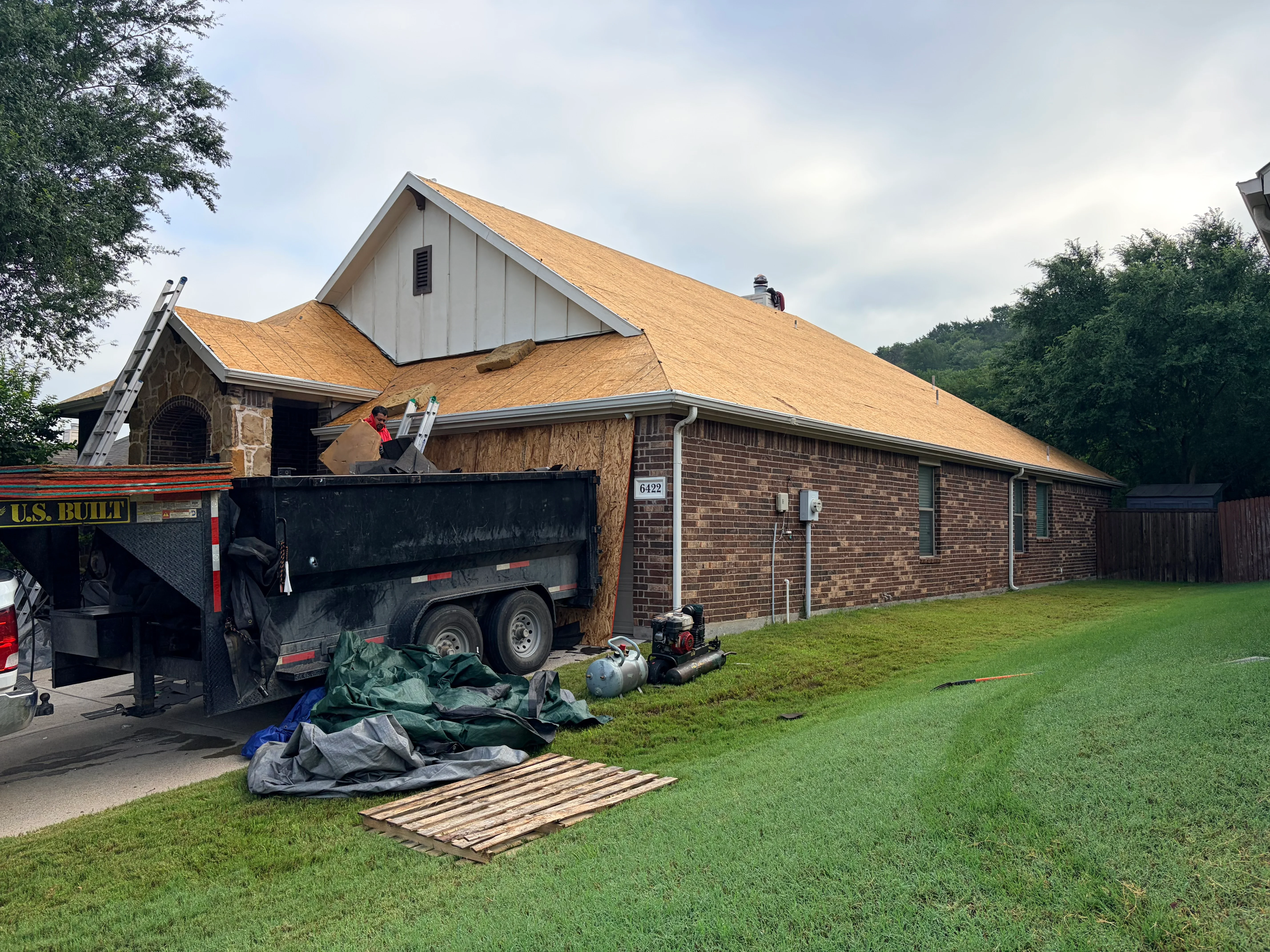 New architectural shingles installed on brick home roof with gable vents and proper flashing