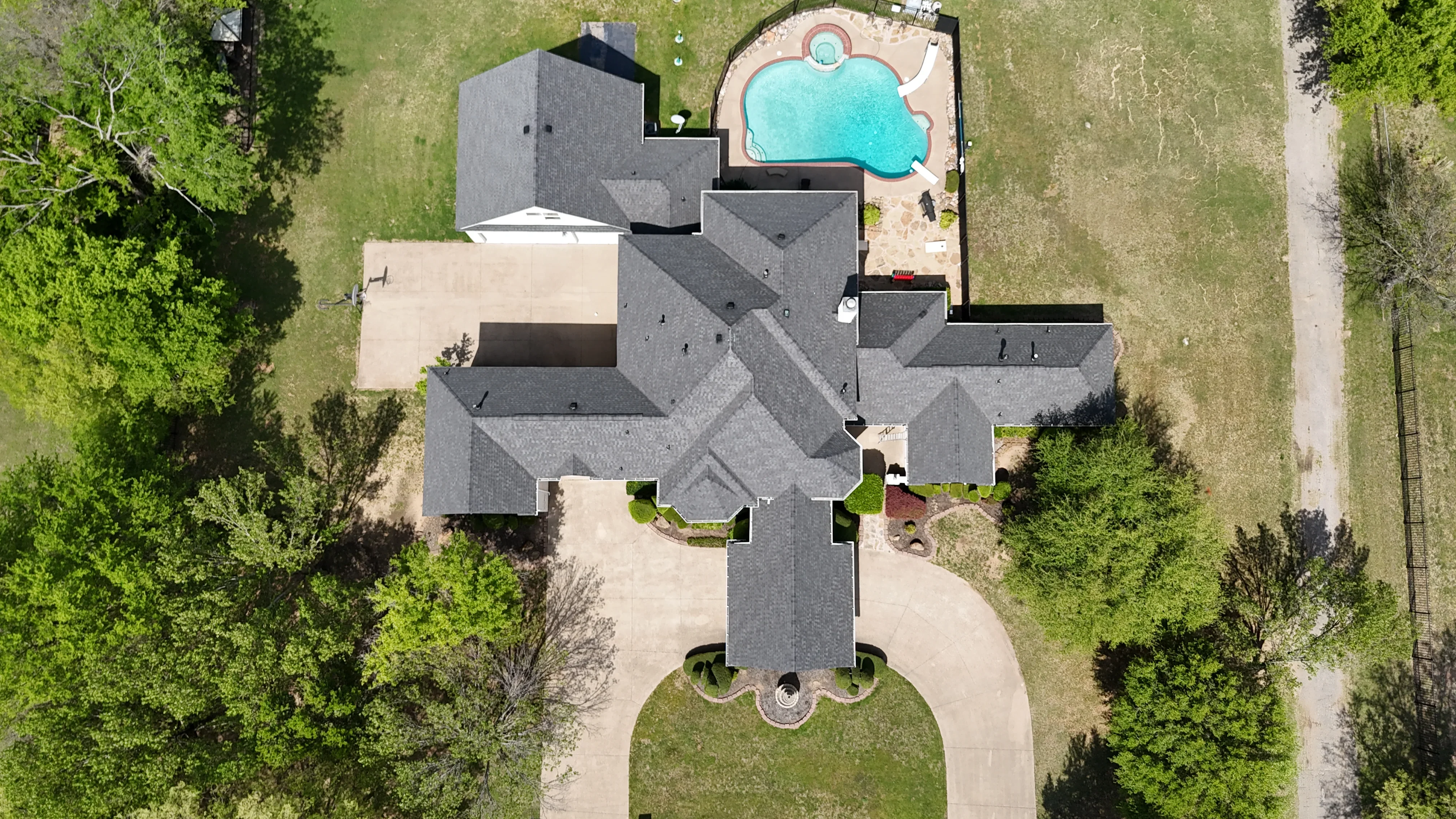 Aerial view of residential home with new charcoal gray asphalt shingle roof installation